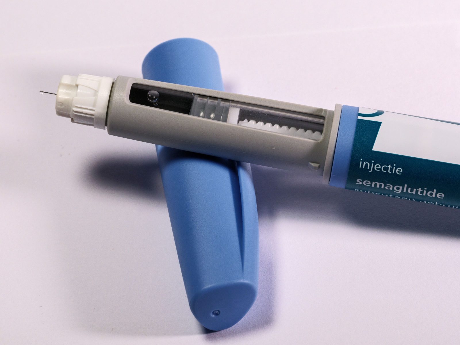 A semaglutide injection pen against a plain background