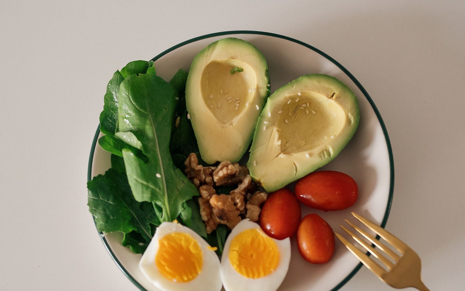 A plate of simple whole food on a pale table in daylight