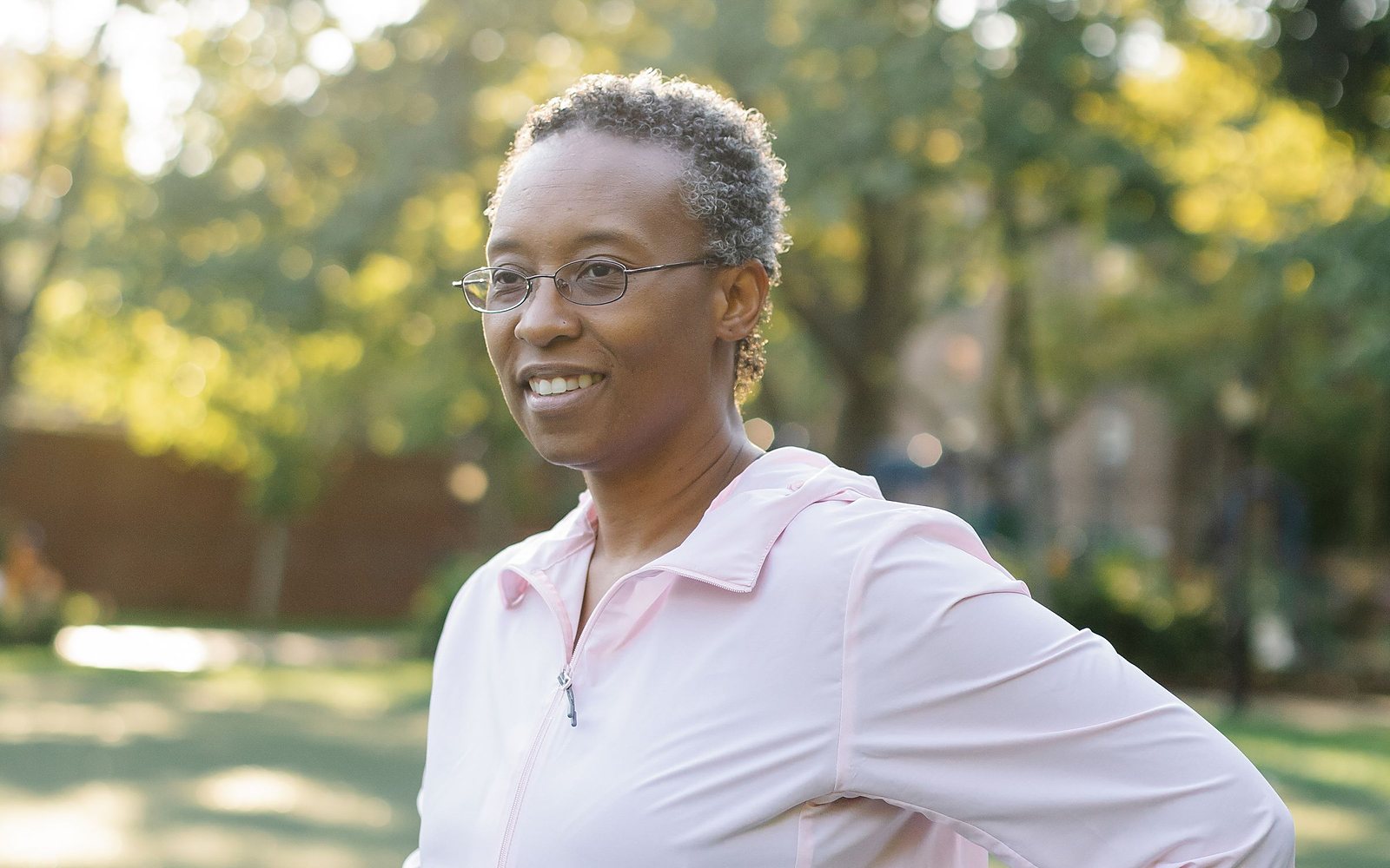 A woman in midlife outdoors in warm morning light